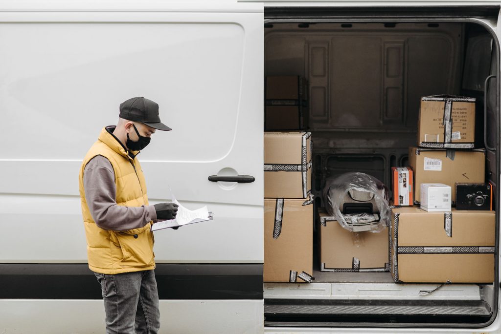 Loading parcels into a long wheel base van ready for deliver berkeley courier service Thame, Wiltshire, berkshire, oxfordshire and surrounding areas in the UK.